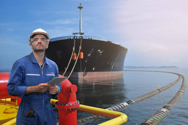 istock Caucasian man engineer staff worker with tablet in hand and oil taker ship concept. 1218321463
