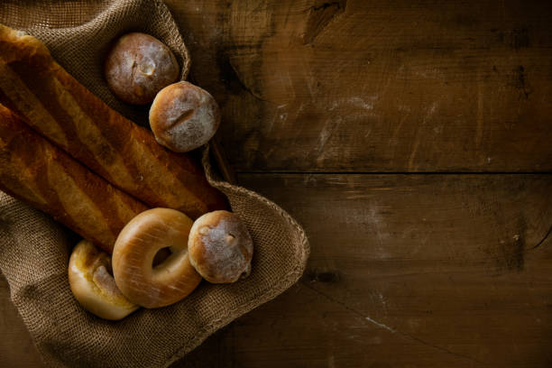 istock Breads,baguettes and bagels on burlap sack. Delicious breads image. 1218321619