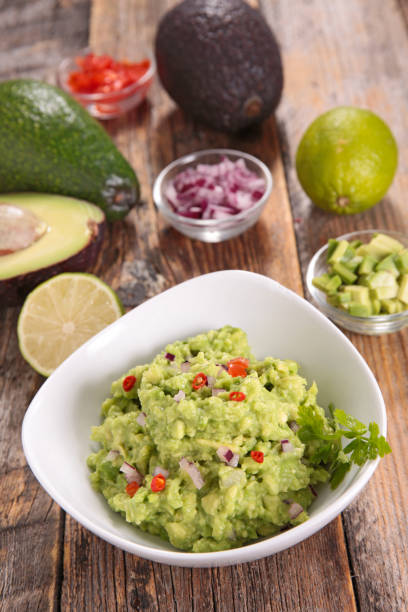istock bowl of guacamole and ingredient 1218321898