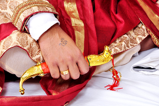 Indian groom holding a wedding knife kirpan