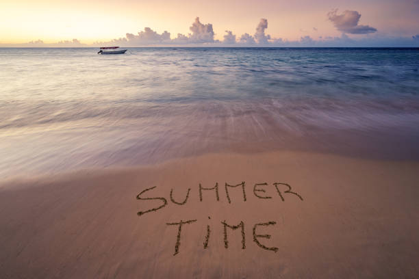 istock Handwritten Summer time on sandy beach at sunset 1218325745