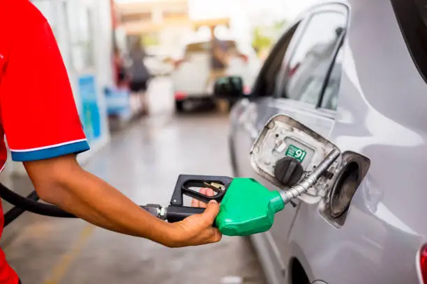 Photo of Hand refilling the car with fuel at the gas  station, car in gas station