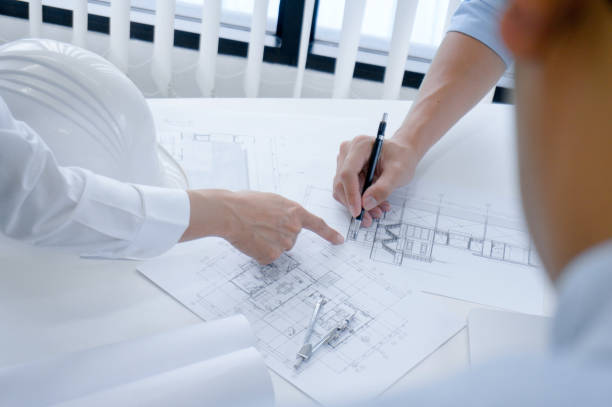 istock Colleagues interior designer Corporate Achievement Planning Design on blueprint Teamwork Concept with compasse. 1218327749