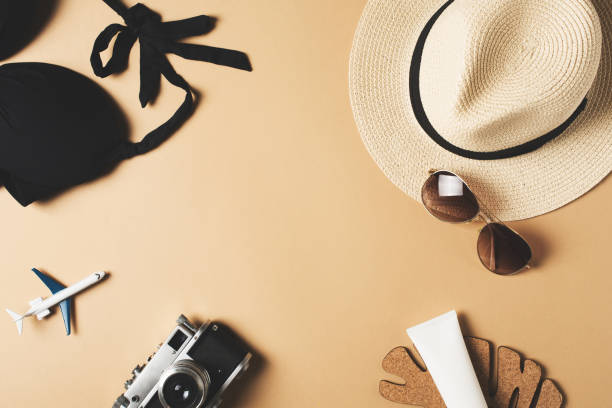 istock Vacation concept with bikini, hat, camera and sunglasses, frame on beige 1218331703