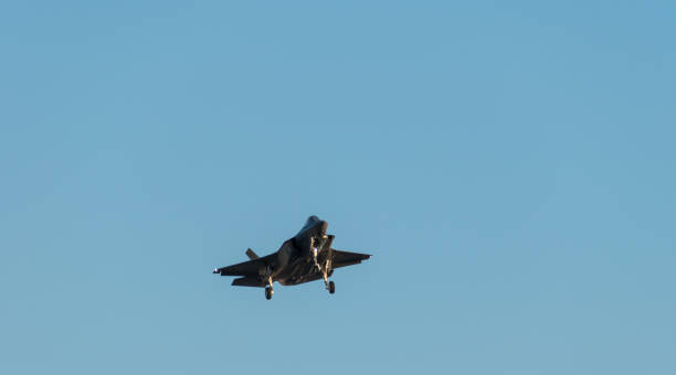 istock Jet fighter flying with landing gear down 1218333241
