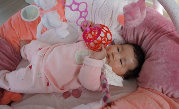 istock baby playing with O'ball 1218335682