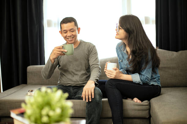 istock Couple relaxing on sofa in their new home 1218336521