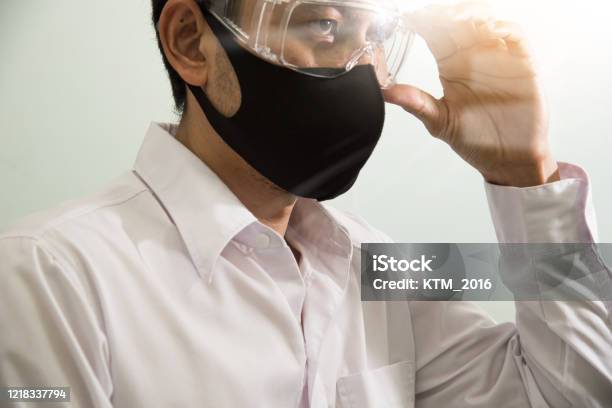 Businessman Wearing Safety Google And Mask To Protect Virus Covid19 Stay Home Work From Home Social Distance Concept Stock Photo - Download Image Now