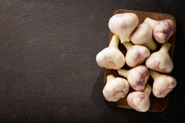 istock Fresh garlic on a wooden board 1218338001