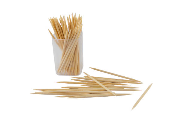 istock Wooden toothpicks in plastic bottle and scattering on white background 1218340162