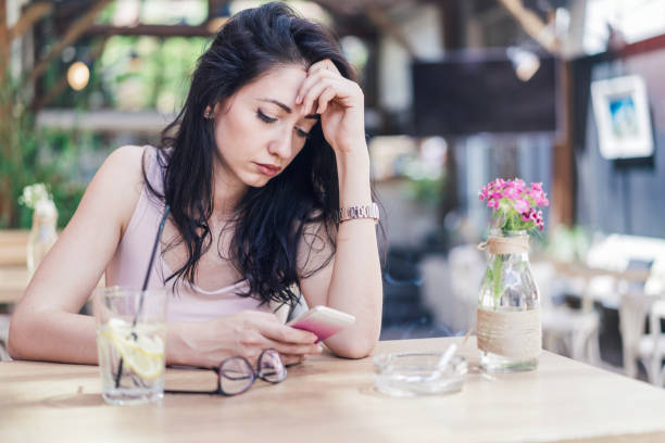 istock Sad woman sitting in a bar 1218341686
