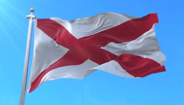 Flag of Alabama state, region of the United States, waving at wind