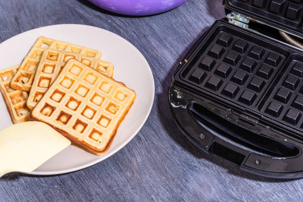 istock Cooking home Belgian waffles in an electric waffle iron. 1218342637