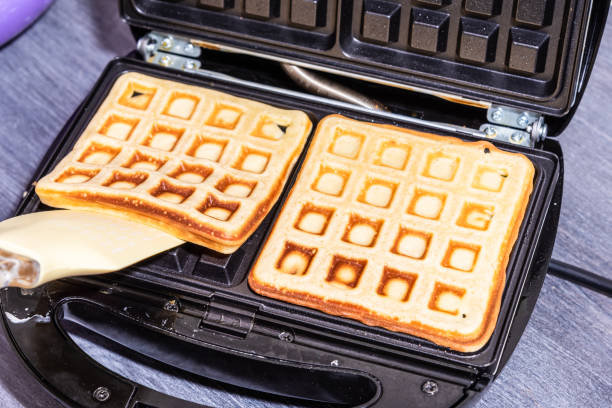 istock Cooking home Belgian waffles in an electric waffle iron. 1218342860