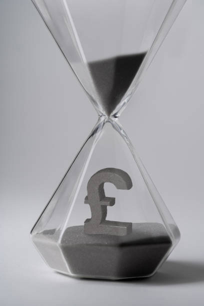 istock Sand clock for business concept and currency exchange 1218345835