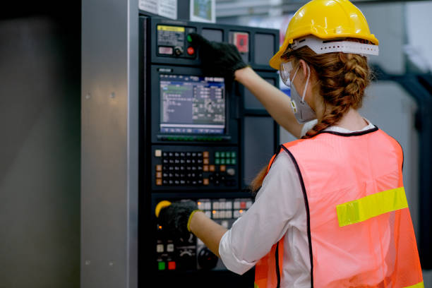 istock Beautiful factory woman with mask work with machine by monitoring and control function button 1218346609
