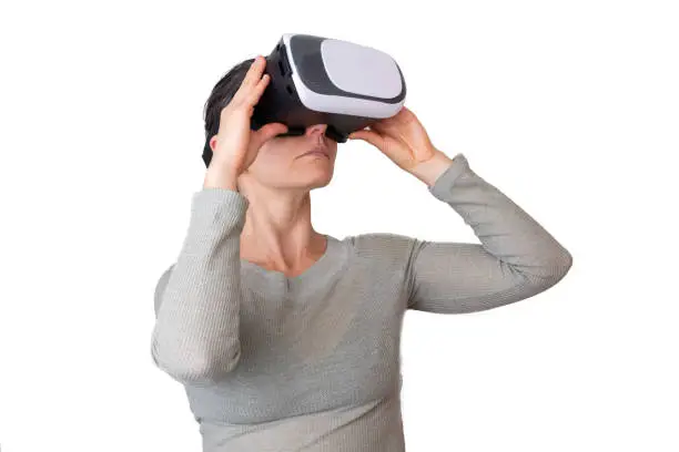 Woman looking up while using virtual reality headset - isolated on white with copy space