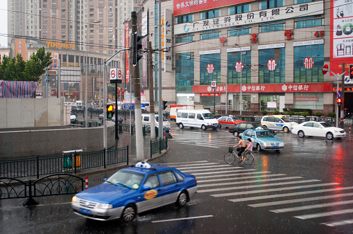 Taxi in a rain day in Shanghai, China. Volkswagen Santana taxis manufactured in a Shanghai joint venture with the German car. Shanghai has approximately 45,000 taxis, operated by over 150 taxi companies. Several companies have taxis in their own colors. There are seven more popular companies - Dazhong Taxi Company with their cars in sky blue; Qiangsheng with their cars in orange; Jinjiang white; Bashi green; Haibo sapphire blue; Fanlanhong red; and Lanse Lianmeng in navy blue. Of all the companies, Dazhong and Qiangsheng are most strongly recommended. Taking taxis in Shanghai is more expensive than in other cities. In the daytime, the price is CNY13 for the first three kilometers (1.9 miles), an additional charge of CNY2.4 for every succeeding kilometer within 10 kilometers (6.2 miles) and CNY3.6 for every succeeding kilometer after 10 kilometers. At night from 23:00 to 05:00 the next morning, the fare is CNY17 for the first three kilometers, an additional charge of CNY3.1 for every succeeding kilometer within 10 kilometers and CNY4.1 for every succeeding kilometer after 10 kilometers. You can bargain over prices when taking taxis at night. Please note the charge will be rounded when you pay and Shanghai Public Transportation Card can be used on most taxis. Anything unreasonable, you may file a complaint by calling 021-63232150 or to the specific taxi company by telephoning the number displayed on the car.