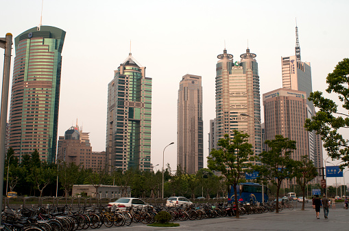 Shanghai, Pudong District, China. Pudong, formerly romanized as Pootung, is a district of Shanghai, China, located east of the Huangpu River across from the historic city center of Shanghai in Puxi. The name refers to its historic position as \