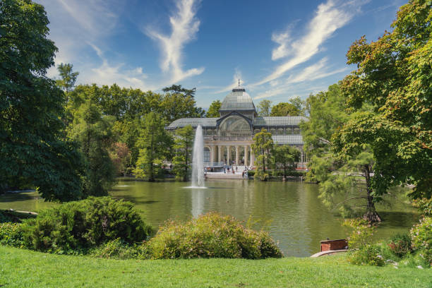 Panoramic of the Crystal Palace in the Retiro Park of Madrid with the cloudy sky Panoramic of the Crystal Palace in the Retiro Park of Madrid with the cloudy sky palacio de cristal photos stock pictures, royalty-free photos & images