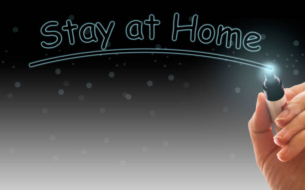 istock Inscription stay at home. Outbreak Warning. written white chalk on blackboard in connection with epidemic of coronavirus worldwide 1218348536