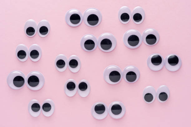 istock Creative layout of many googly eyes on pink background. Minimal concept. 1218350089