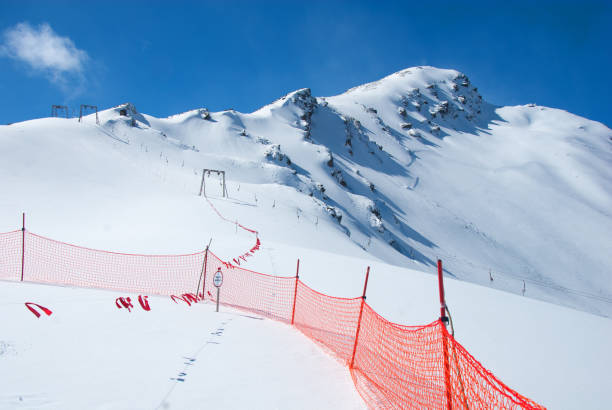 Empty ski racing course with sets of gates. Super G skiing winter sport.  Giant slalom race.  Snow skiing,   perfect ski slope, fresh prepared  piste,  ski resorts.  Snowcapped mountain  Dolomite super ski area. Ski resort. Sellaronda, italy, Europe. No People
