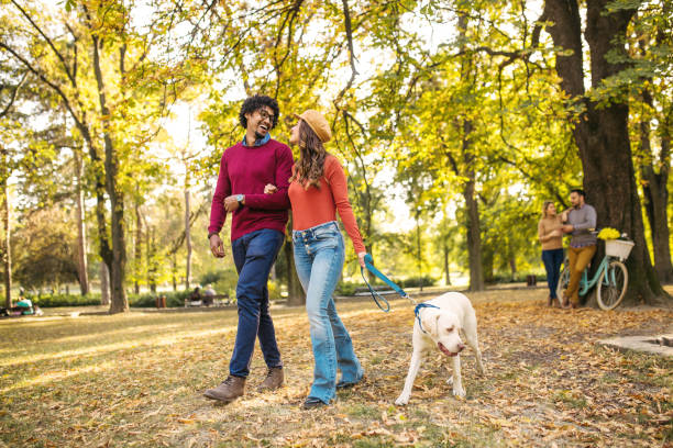 istock Beautiful multiethnic couple enjoying together with dog 1218359047