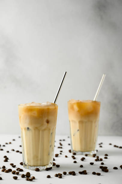 istock Two glasses with iced coffee and scattered grains on a light concrete surface. 1218361894