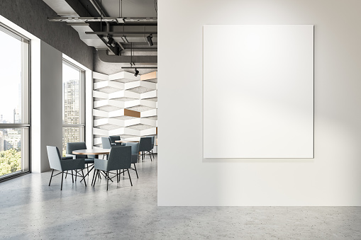 Interior of modern industrial style restaurant with white and geometric pattern walls, grey ceiling, concrete floor and round tables with grey armchairs. Mock up poster to the right. 3d rendering
