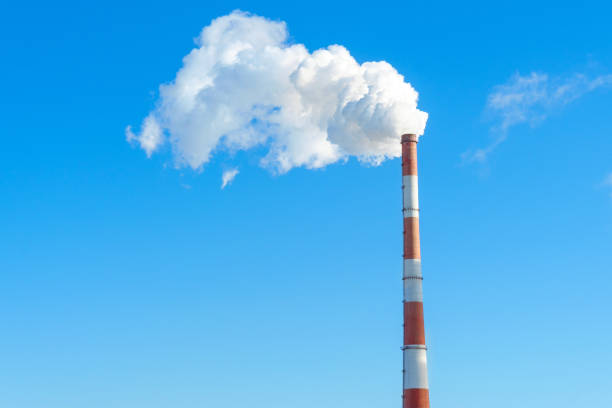 istock large blue pipe releases white steam into the blue sky. space for text, copy space 1218362333