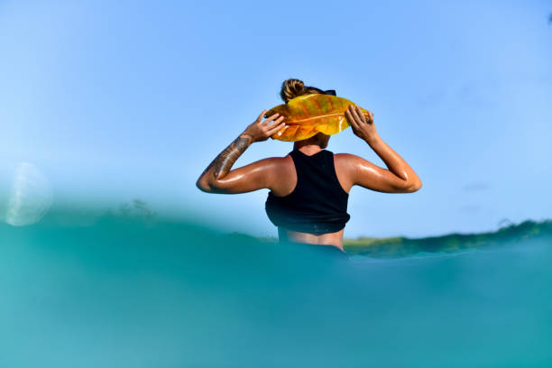 istock Enjoying the Moment: Woman Standing in Ocean Blue Water 1218363873