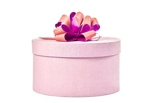 Round gift box with bow, isolated. Pink closed box for gift on white background. Package for surprise for any holiday: Valentine's day, Christmas, Anniversary, Wedding and other celebration