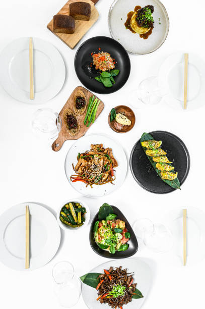 istock Assorted Chinese food set. Noodles, fried rice, dumplings, peking duck, dim sum, spring rolls. Famous dishes on table.  Gray background. Top view. 1218365813