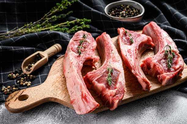 istock Raw fresh lamb ribs with pepper and thyme. Organic meat. White background. Top view 1218366668