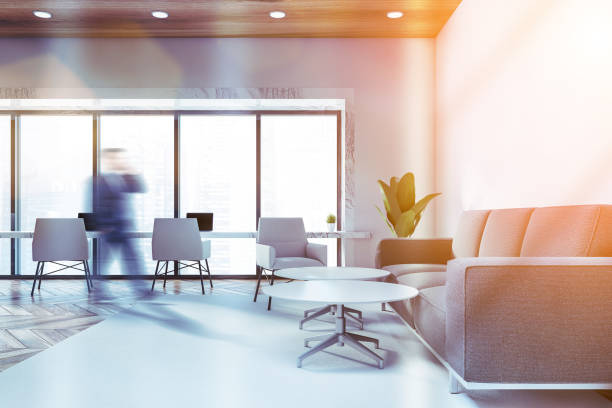 istock Businessman walking in white office waiting room 1218367140