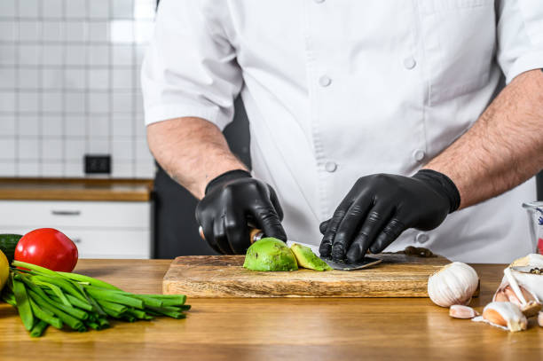 istock A chef in black gloves prepares guacamole from fresh avacado Hass 1218367942