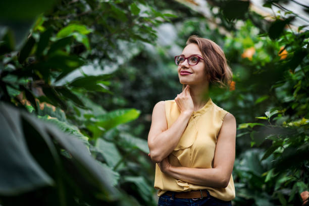 istock Young woman standing in botanical garden. Copy space. 1218368406