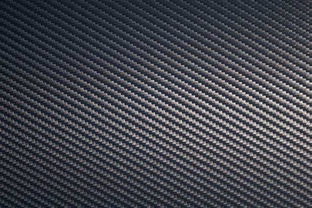 istock Close up of grey diagonal oriented woven carbon fibre sheet surface. 1218368752