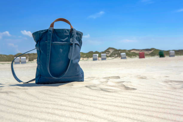 istock Blue textile beach bag on a sandy tropical beach 1218369637