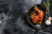 Cooked roasted chicken legs. Grilled meat. Blacked background. Top view. Copy space