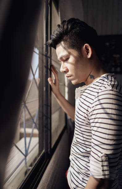 istock Asian lonely man in bedroom alone at home 1218369746