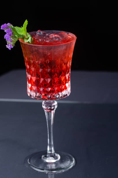 istock red refreshing alcoholic cocktail made from cherry juice decorated with mint and flowers 1218372342