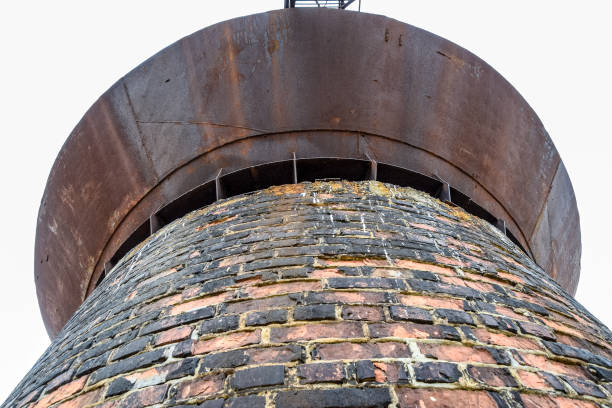 istock Rusty water tower against sky. Old water pump. 1218372560