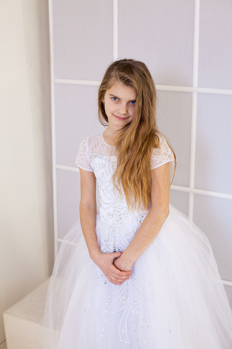 girl of twelve years in a white dress