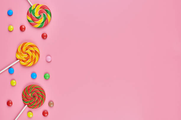 istock Sweet lollipops and candy on pink background 1218373804