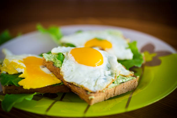 two fried eggs sunny side up, sprinkled with smoked paprika and black pepper, toast alongside