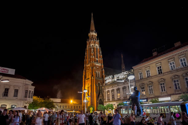 Crowd gathering at a food market on the main square of Osijek, Ante Starcevic square. The Cathedral of the city can be seen in the background. Picture of Ante Starcevic, the main square of Osijek. Osijek is the fourth largest city in Croatia. It is the largest city and the economic and cultural centre of the eastern Croatian region of Slavonia, as well as an administrative and political hub osijek photos stock pictures, royalty-free photos & images