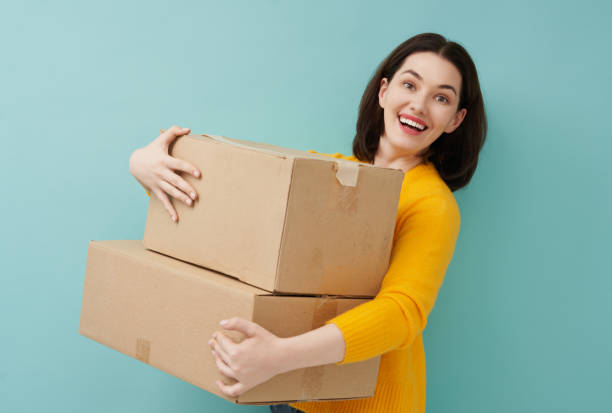istock woman is holding cardboard box 1218377383