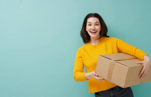 istock woman is holding cardboard box 1218377389